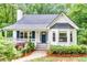 Inviting home with blue shutters, a matching front door, and a charming front porch at 138 Hartwood Dr, Woodstock, GA 30189