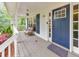 Inviting front porch with seating, classic door, and charming details at 138 Hartwood Dr, Woodstock, GA 30189