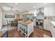 Modern kitchen features an island, stainless steel appliances, and a dining area with natural light at 138 Hartwood Dr, Woodstock, GA 30189
