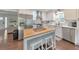 Bright kitchen with stainless appliances, island with breakfast bar, and wood floors at 138 Hartwood Dr, Woodstock, GA 30189