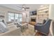 Cozy living room features a stone fireplace, built-in shelving, and comfortable seating at 138 Hartwood Dr, Woodstock, GA 30189