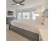 Spacious main bedroom with a ceiling fan, television, and a gray dresser and bed frame at 138 Hartwood Dr, Woodstock, GA 30189