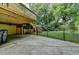 Lower level backyard and patio featuring staircase to deck, iron fence, and play structure at 1486 Maple Ridge Dr, Suwanee, GA 30024