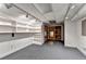 Spacious basement featuring gray carpet, track lighting, and built-in shelving at 1486 Maple Ridge Dr, Suwanee, GA 30024