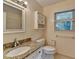 Functional bathroom with granite countertop, a toilet, and a window offering natural light and ventilation at 1486 Maple Ridge Dr, Suwanee, GA 30024