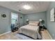 Cozy bedroom with soft blue walls, a comfortable bed, and a window for natural light, creating a serene atmosphere at 1486 Maple Ridge Dr, Suwanee, GA 30024