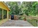 Deck with wooden railing, grill, potted plant, and a backyard view at 1486 Maple Ridge Dr, Suwanee, GA 30024