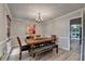 Traditional dining room featuring a rustic wood table set beneath an elegant chandelier at 1486 Maple Ridge Dr, Suwanee, GA 30024