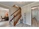 Inviting entryway features staircase, stylish decor, and durable wood-look flooring at 1486 Maple Ridge Dr, Suwanee, GA 30024