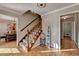 Inviting foyer featuring beautiful hardwood floors, staircase, and flows to the dining room at 1486 Maple Ridge Dr, Suwanee, GA 30024