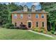 Charming brick home featuring a well-manicured lawn and lush landscaping creating great curb appeal at 1486 Maple Ridge Dr, Suwanee, GA 30024