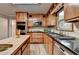 Modern kitchen with light wood cabinets, an island, and stainless steel appliances at 1486 Maple Ridge Dr, Suwanee, GA 30024