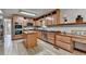 Spacious kitchen features stainless steel appliances, an island, and plentiful wooden cabinetry at 1486 Maple Ridge Dr, Suwanee, GA 30024
