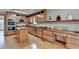 Warm kitchen featuring wood cabinets, an island, hardwood floors, and stainless steel appliances at 1486 Maple Ridge Dr, Suwanee, GA 30024