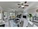 Bright living room with fireplace, gray carpet, neutral paint, ceiling fans, and views to the backyard at 1486 Maple Ridge Dr, Suwanee, GA 30024