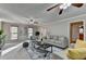 Spacious living room with neutral paint, carpet and furnishings, and three bright windows at 1486 Maple Ridge Dr, Suwanee, GA 30024