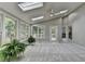 Light-filled sunroom featuring multiple skylights and windows offering serene views of the surrounding greenery at 1486 Maple Ridge Dr, Suwanee, GA 30024