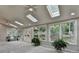 Spacious sunroom boasting several skylights and large windows, seamlessly blending indoor and outdoor living spaces at 1486 Maple Ridge Dr, Suwanee, GA 30024