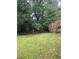 View of the backyard featuring mature trees offering plenty of shade for outdoor activities at 604 Pepperwood Ln, Stone Mountain, GA 30087