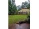 A view of the backyard with a fence, patio and lush green lawn at 604 Pepperwood Ln, Stone Mountain, GA 30087