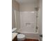 Clean bathroom featuring a shower-tub combination with a shower head and a toilet at 604 Pepperwood Ln, Stone Mountain, GA 30087
