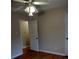 Bedroom features hardwood floors, ceiling fan, and entry to another room at 604 Pepperwood Ln, Stone Mountain, GA 30087