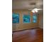 Bright bedroom with hardwood floors and three windows offering natural light and views at 604 Pepperwood Ln, Stone Mountain, GA 30087