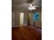 A large bedroom with hardwood floors, ensuite bathroom, and ceiling fan at 604 Pepperwood Ln, Stone Mountain, GA 30087