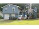 Charming two-story home with blue siding, stone accents, and a well-maintained front yard at 604 Pepperwood Ln, Stone Mountain, GA 30087
