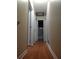 Hallway with hardwood floors leading to bedrooms and a bathroom at 604 Pepperwood Ln, Stone Mountain, GA 30087