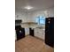 Functional kitchen with black appliances and white cabinetry, ready for culinary adventures at 604 Pepperwood Ln, Stone Mountain, GA 30087