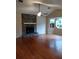 Spacious living room featuring a stone fireplace, ceiling fan, and large windows for natural light at 604 Pepperwood Ln, Stone Mountain, GA 30087