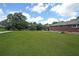Spacious backyard with lush green lawn, mature trees, and ample space for outdoor activities at 629 Birchwood Rd, Marietta, GA 30060