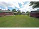 Large backyard featuring a storage shed, lush lawn, and mature shade trees at 629 Birchwood Rd, Marietta, GA 30060