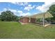 Backyard brick home with large covered patio and lawn at 629 Birchwood Rd, Marietta, GA 30060