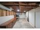 Unfinished basement offers storage and utility access, with exposed wood ceiling and white painted block walls at 629 Birchwood Rd, Marietta, GA 30060