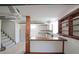 The basement features a wooden bar, carpet, and access to other basement areas and the staircase at 629 Birchwood Rd, Marietta, GA 30060