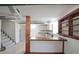 Basement featuring built-in wooden shelves, cabinets and a bar, plus carpeted stairs to the upper level at 629 Birchwood Rd, Marietta, GA 30060