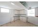 Basement features white walls and cabinets with a countertop, plus natural light from two windows at 629 Birchwood Rd, Marietta, GA 30060