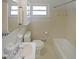 Clean bathroom with white tile, toilet, sink, and bathtub at 629 Birchwood Rd, Marietta, GA 30060