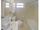 Vintage bathroom featuring neutral tile, built-in shelving, and well-maintained fixtures at 629 Birchwood Rd, Marietta, GA 30060