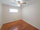 Bright bedroom with hardwood floors, large window, and ceiling fan at 629 Birchwood Rd, Marietta, GA 30060