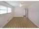 This bedroom features paneled walls, tiled floors, a ceiling fan, and a window at 629 Birchwood Rd, Marietta, GA 30060