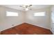 Bedroom with hardwood floors, two windows, and neutral colored walls at 629 Birchwood Rd, Marietta, GA 30060