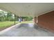 View under the carport showing the brick home, shed, and side yard at 629 Birchwood Rd, Marietta, GA 30060