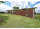 Brick home with a carport and manicured lawn showcasing a classic design at 629 Birchwood Rd, Marietta, GA 30060