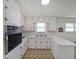 U-shaped kitchen with white cabinetry, retro countertop design, and vintage appliances at 629 Birchwood Rd, Marietta, GA 30060