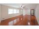 Bright living room featuring gleaming hardwood floors, a ceiling fan, and a front-facing window at 629 Birchwood Rd, Marietta, GA 30060
