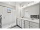 Bright bathroom featuring double sinks, a glass shower, and modern finishes at 631 Avondale Creek Dr, Decatur, GA 30032