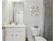 Bright bathroom featuring a white vanity, toilet, and tiled shower with glass door at 631 Avondale Creek Dr, Decatur, GA 30032